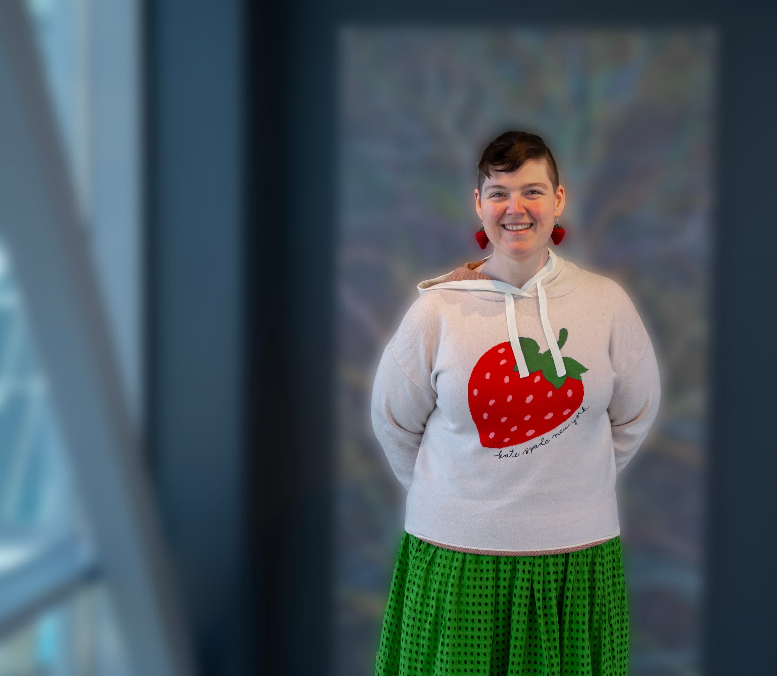 portrait of person (sam helmick) in white sweater with strawberryprint. foto.