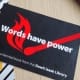 brosjyre med teksten "Words have power" fra the dawit isaak library ligger på en bordflate. foto